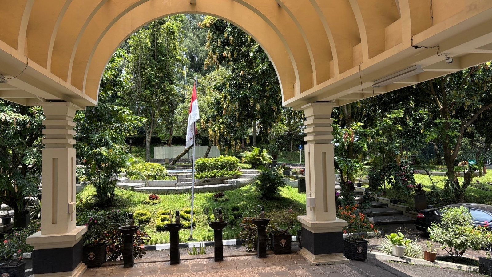 Garden on the UPI campus seen through an arch
